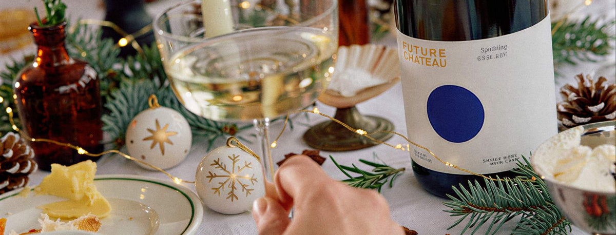Christmas table set with Future Château Sparkling, glasses and festive decorations
