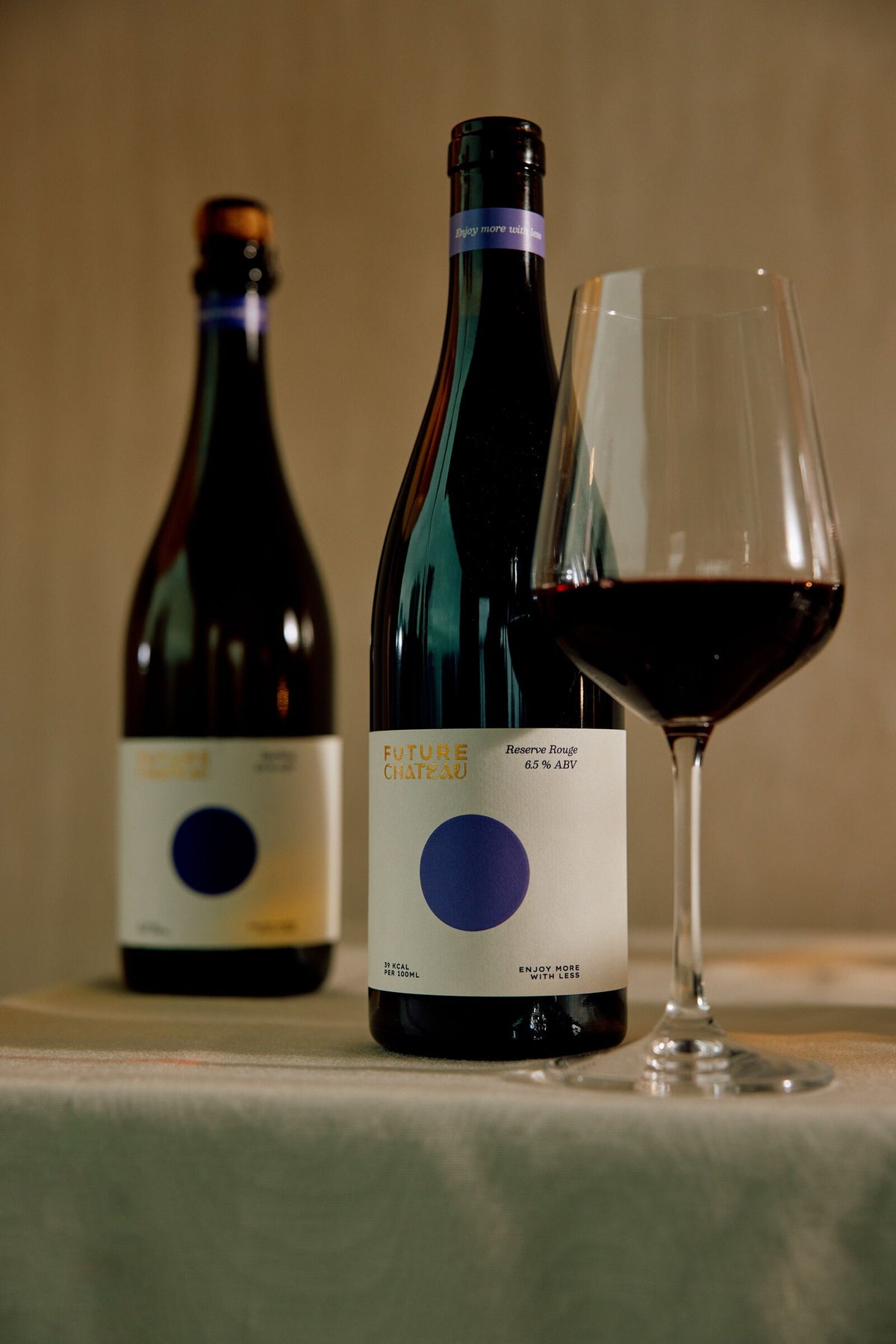 Future Château Sparkling and Reserve Rouge bottles with a glass of red wine
